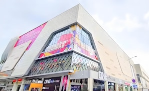 A modern building with a unique angular design, featuring a glass facade and a prominent 'ONE pub' sign. - Ji Hotel Guangzhou Baiyun Airport Renhe Metro (Guangzhou)