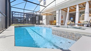 A swimming pool with a glass enclosure, lounge chairs, and umbrellas. - 2-Story Slide! Mickey & Minnie Clubhouse! MARIO Galaxy! Minion Room! (Clermont)