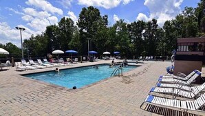 A swimming pool with lounge chairs and umbrellas. - 21A Edelweiss w/ Hot Tub (Gatlinburg)