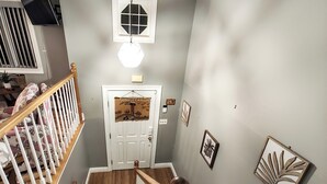 A staircase with wooden railings and a white door at the top.