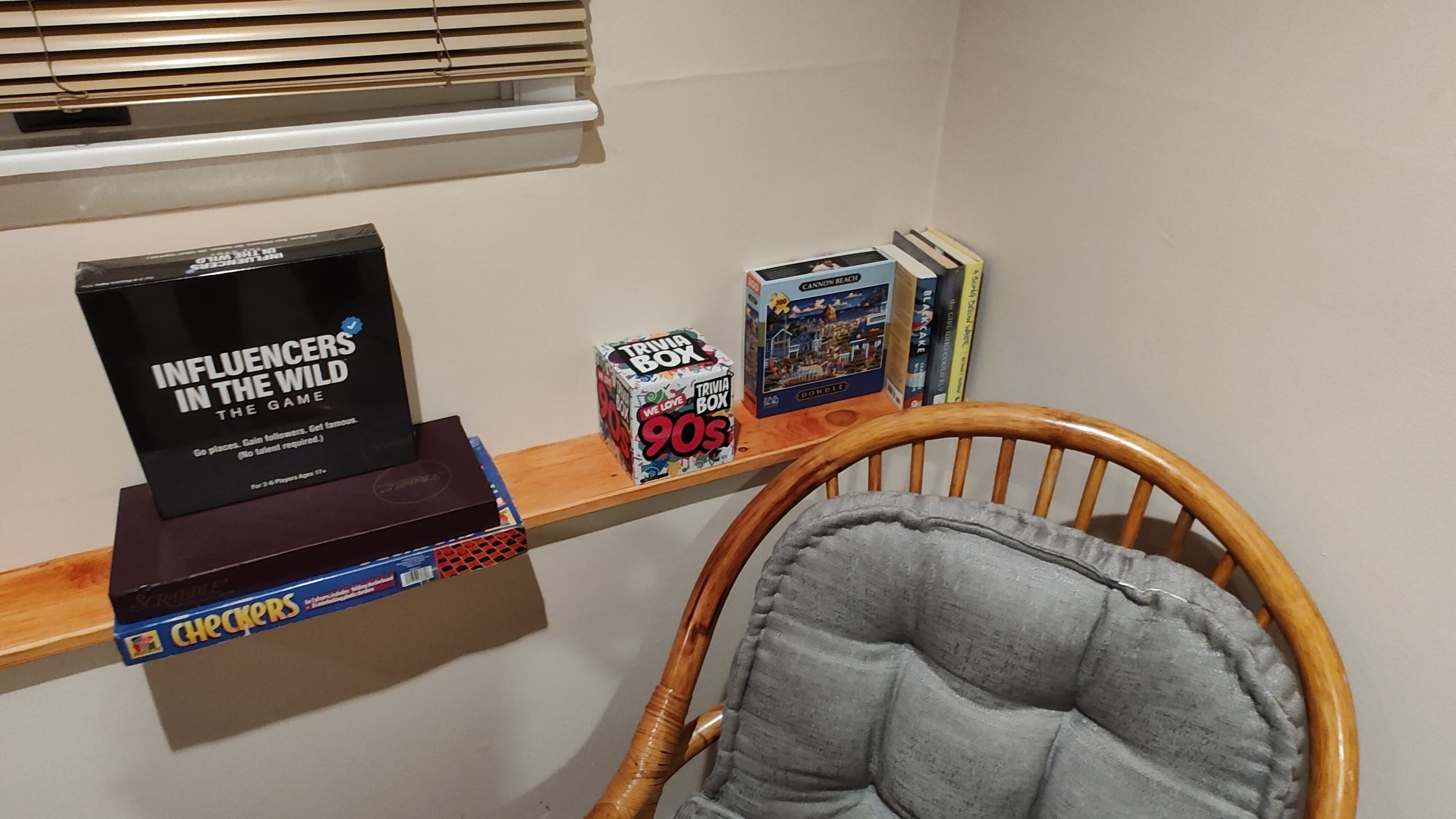 A shelf with books and a trivia box.