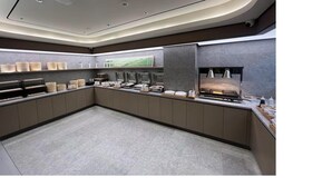 A modern, well-lit kitchen area with a long counter, various appliances, and storage units. - Ji Guangzhou Beijing Road Pedestrian St Cangbian (Guangzhou)