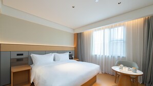 A modern hotel room with a large bed, bedside tables, a round table with chairs, and a window with curtains. - Ji Guangzhou Beijing Road Pedestrian St Cangbian (Guangzhou)