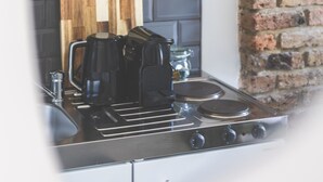 A kitchen with a built-in microwave, a coffee maker, and a stove. - Stylish & Petit Studio flat w/great tube connectio (Greater London)