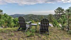 Two Adirondack chairs facing a mountainous landscape with a clear sky. - Cozy Haven - 4 En-Suite BR + Hot Tub + Fire Pit (Lead)
