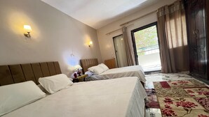 A hotel room with two beds, a nightstand, a lamp, and a view of the outdoors through a window with curtains. - Vysta pyramids hotel Cairo 
View pyramids 
renovated rooms
Restaurant with view (Giza Governorate)