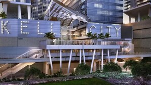 A modern hotel with a prominent 'KELL CITY' sign, multiple floors, and a rooftop terrace. - Brickell Bay Condo with Views + Parking | Sleeps 6 (Miami)