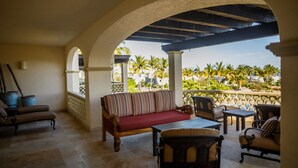 A covered outdoor seating area with a sofa, chairs, and a table. - Las Mañanitas LM F4205 (San José del Cabo)