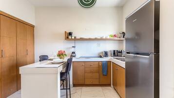 Apartment, 1 King Bed, Kitchen (Maia Cabo(03-05)) | Private kitchen | Coffee/tea maker, dining tables