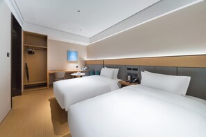 A hotel room with two beds, a desk, a chair, a wardrobe, and a bedside table with a phone. - Ji Hotel Guangzhou Caihongqiao Metro Station (Guangzhou)