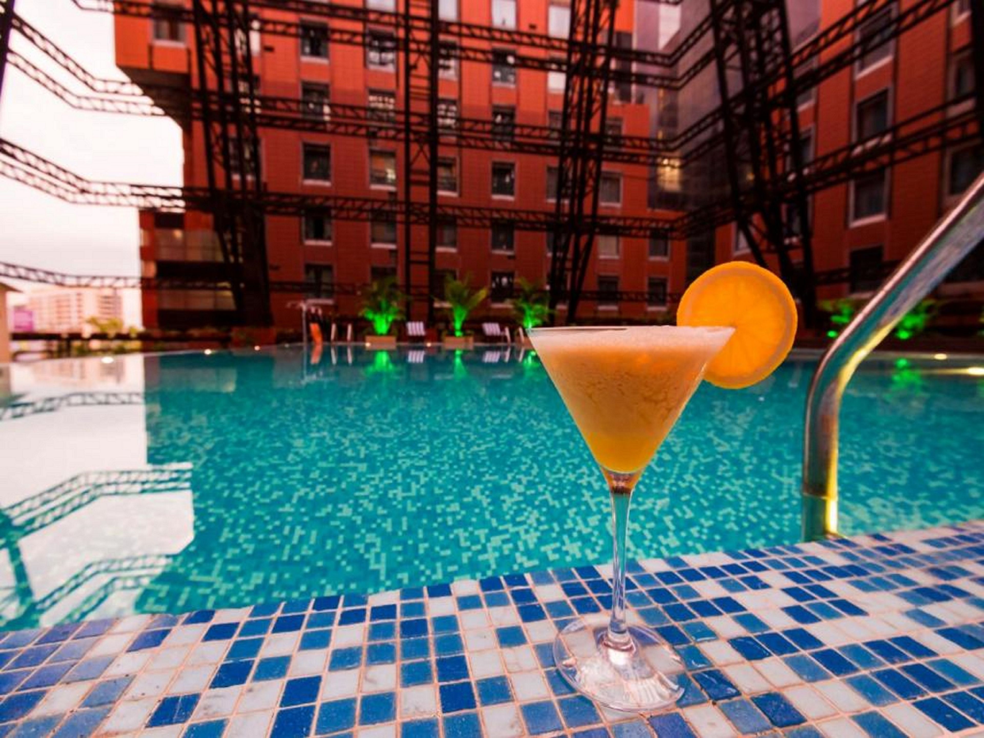 A pool area with a clear view of a building in the background.