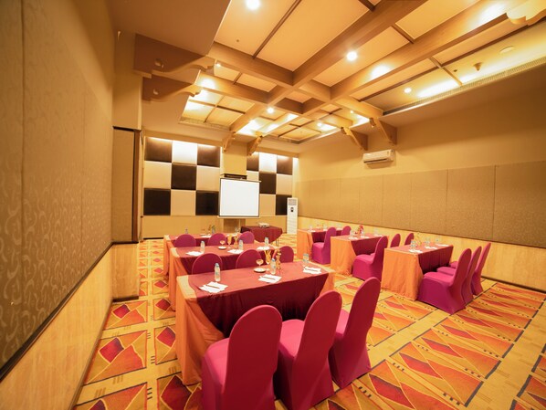 A conference room with a high ceiling, patterned carpet, and tables set for meetings. - The Orchid Hotel, Pune (Pune)