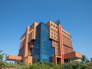 A modern building with a glass facade and a red accent wall. - The Orchid Hotel, Pune (Pune)