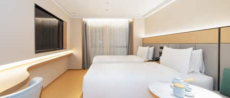 A modern hotel room with a large bed, bedside tables, a desk, and a window with curtains.
