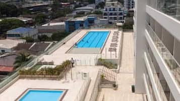 Outdoor pool, open 8:00 AM to 8:00 PM, pool umbrellas