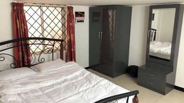 A bedroom with a bed, wardrobe, and a mirror. - Z2 - Maison de ZEN 2, For Serenity, Bliss & Relaxation (Murugeshpalya)