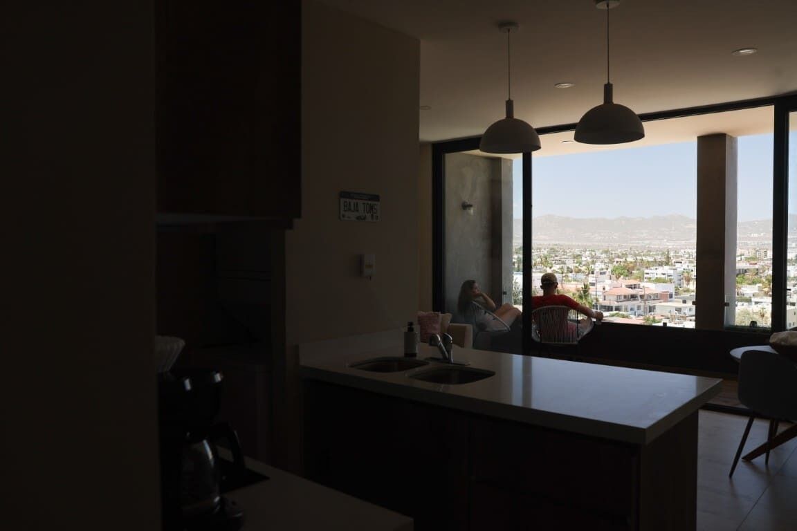 Una cucina moderna con un'ampia finestra, una macchina da caffè e vista sulla città.
