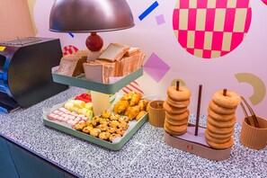 A breakfast buffet with various pastries, sandwiches, and a stack of donuts. - Orange Hotel Guangzhou Yuexiu Park (Guangzhou)