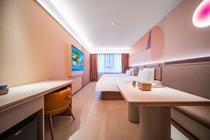 A modern hotel room with a bed, a desk, a chair, and a sofa. - Orange Hotel Guangzhou Yuexiu Park (Guangzhou)