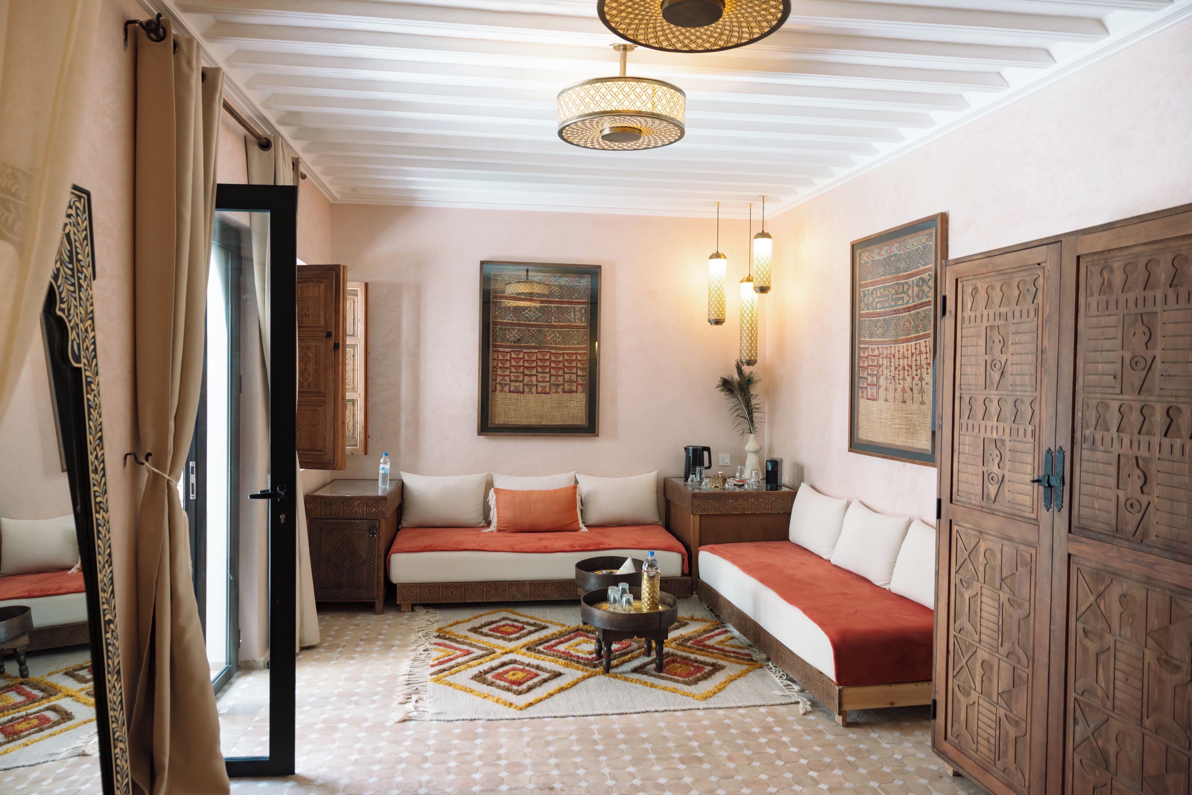A cozy room with a sofa, a small table, and a cabinet.