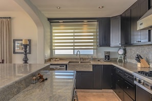 Apartment, Multiple Beds, Balcony, Ocean View (Tortuga Bay TBB 2401) | Private kitchen | Dining tables