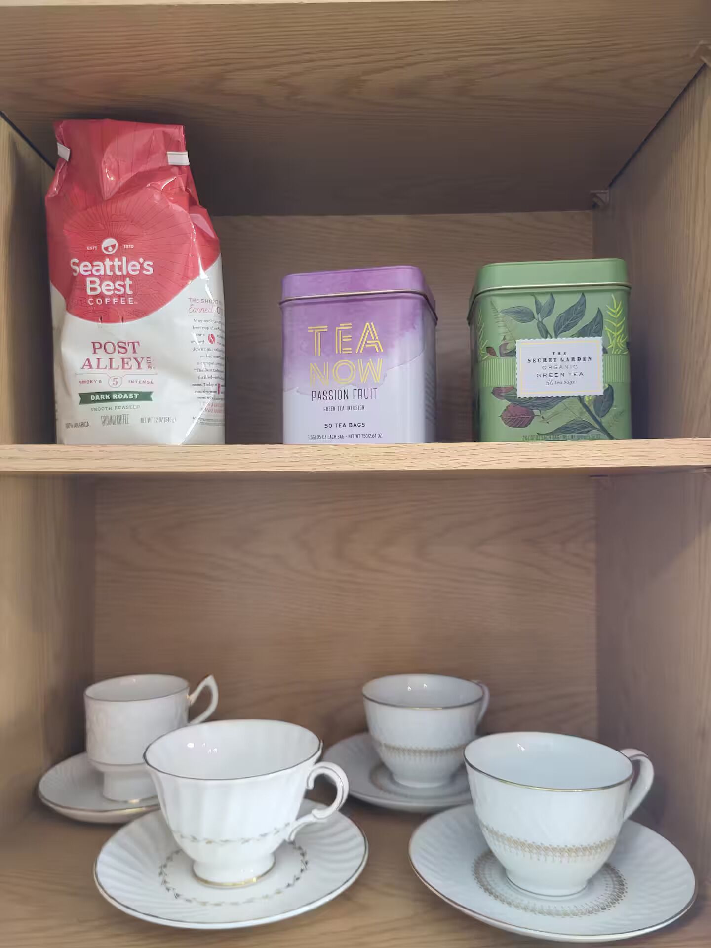 A shelf with coffee products and tea bags.
