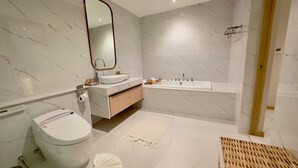 A modern bathroom with a toilet, sink, and bathtub. - Luxtalay Khanom Hotel (Khanom)