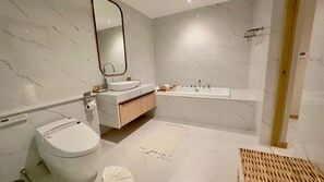 A modern bathroom with a toilet, sink, and bathtub. - Luxtalay Khanom Hotel (Khanom)