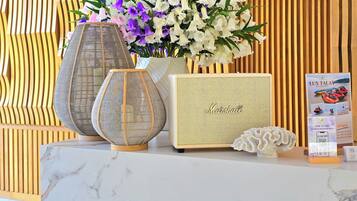 A marble table with a decorative vase, a framed item with text, and a QR code sign.
