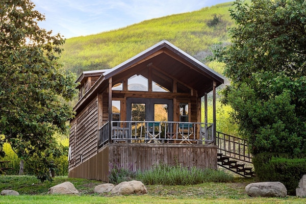 Retreat to a charming cabin surrounded by rolling hills, where comfort and nature blend for the perfect getaway.
