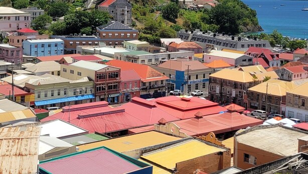 A coastal town with colorful buildings and a clear blue sky. - Oceanview Suites (St. George's)
