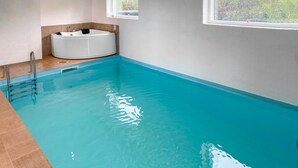 A swimming pool with a hot tub, tiled walls, and a window. - Pet friendly home in Allingåbro with sauna (Allingåbro)