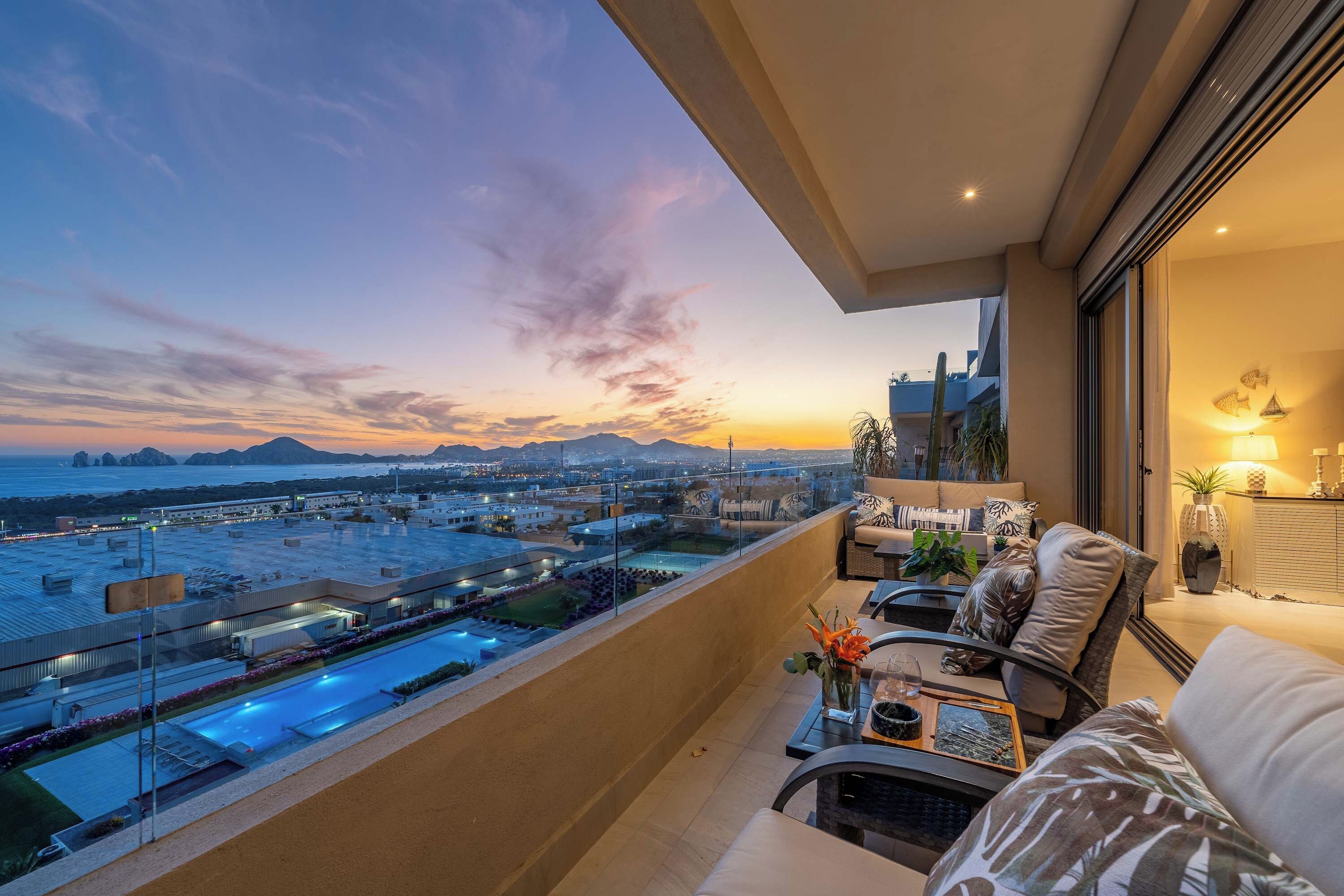 Ein Balkon mit Blick auf eine Stadtlandschaft und einen Pool.