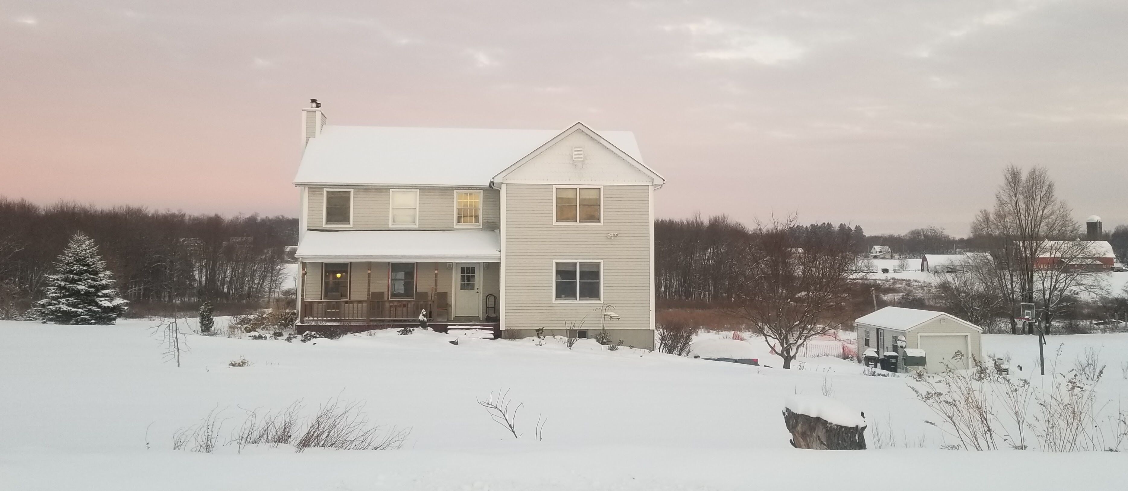 A two-story house with a front porch and a garage.