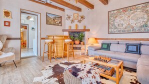 A cozy living room with a sofa, a coffee table with a foosball table, a fireplace, and a map on the wall. - Awesome home in Beauregard-de-Terrasso (Beauregard-de-Terrasso)