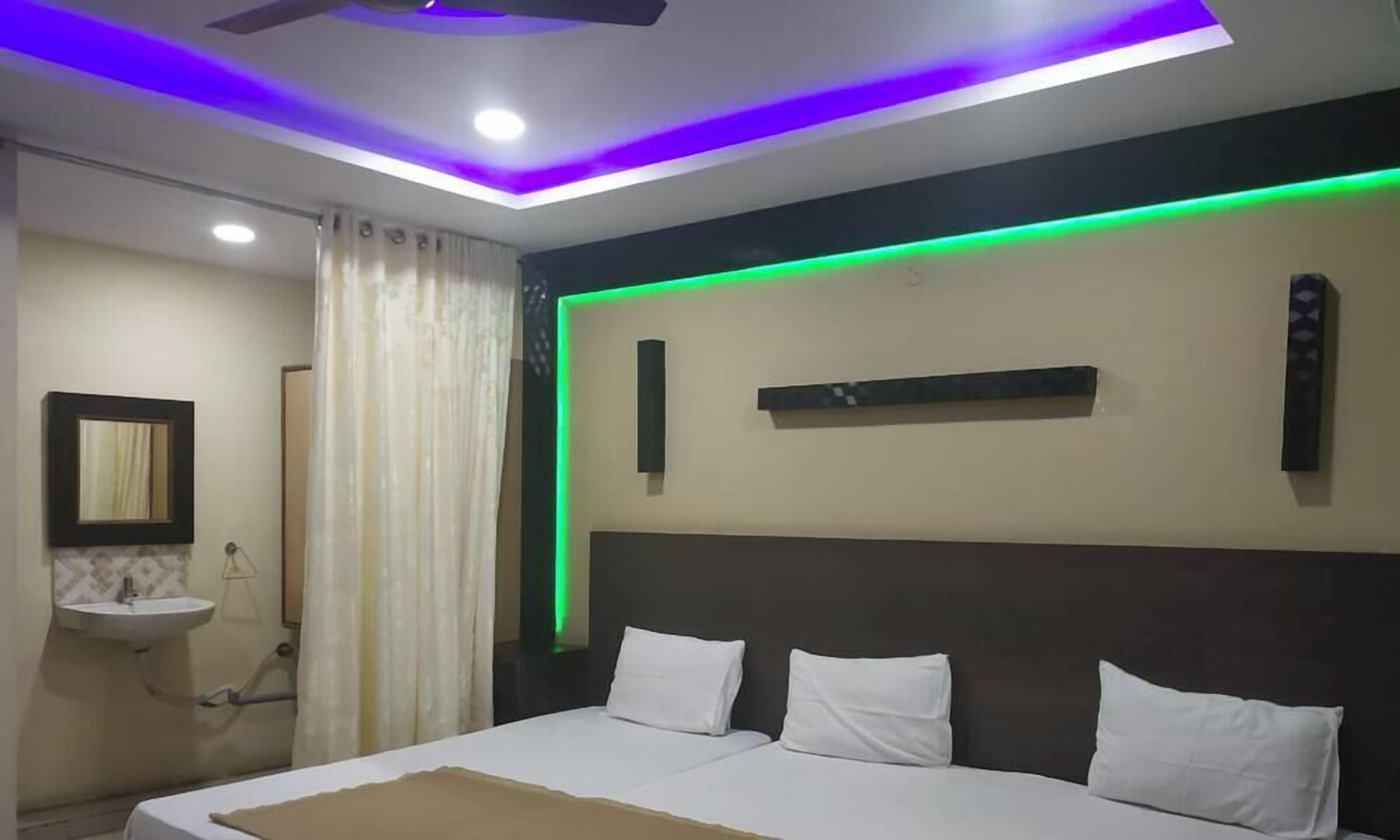 A bedroom with a bed, bedside tables, a mirror, and a window with curtains.
