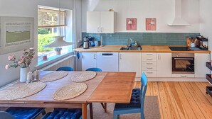 A modern kitchen with white cabinets, a wooden countertop, and a built-in oven. - Beautiful home in ærøskøbing with WiFi (Ærøskøbing)