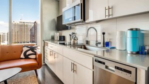 A modern kitchen with a built-in microwave, stainless steel appliances, and a dishwasher. - Boulevard Stays - Phoenix Convention Center (Phoenix)