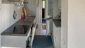 A compact kitchen with a stainless steel sink, a built-in oven, and a microwave. - Awesome home in Kolbjørnsvik with house sea view (Kolbjørnsvik)