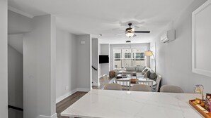 A modern kitchen with a marble countertop, a built-in oven, and a stainless steel dishwasher.
