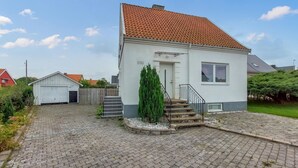 A single-story house with a tiled roof, a small front yard with steps leading to the door, and a mailbox labeled "FYRA". - 4 bedroom beautiful home in åstorp (Åstorp)