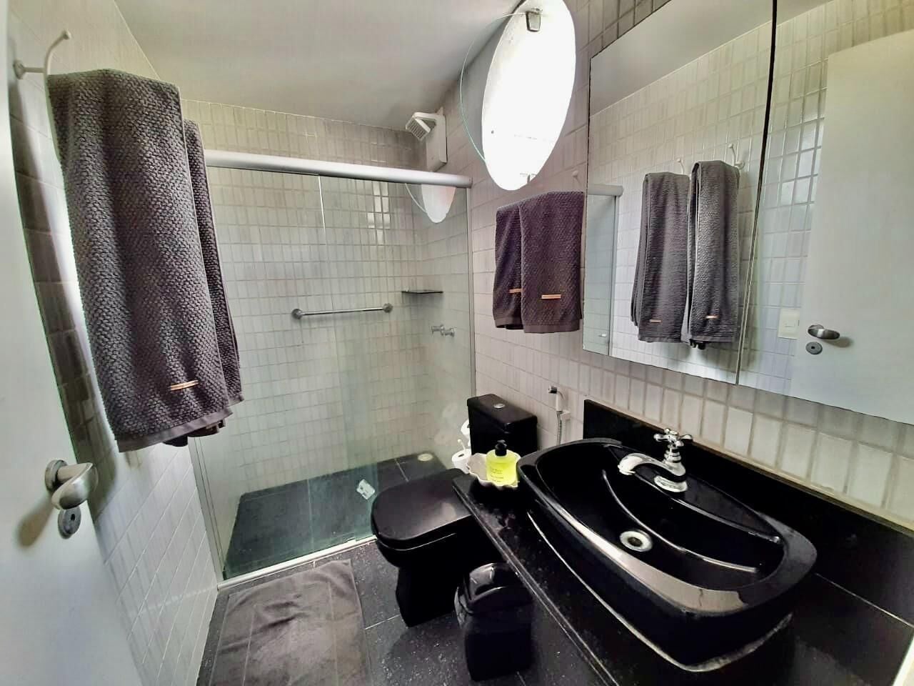 A bathroom with a shower, toilet, and sink.