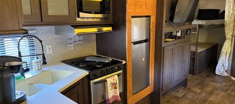 Camper in country setting beside water, near Burning Star Wildlife area