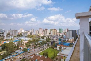 A cityscape with high-rise buildings, a mix of residential and commercial structures, and a clear sky.