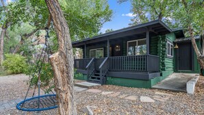 A cabin with a porch, a swing, and a stone pathway. - The Prescott Granite Dell's Getaway! (Prescott)