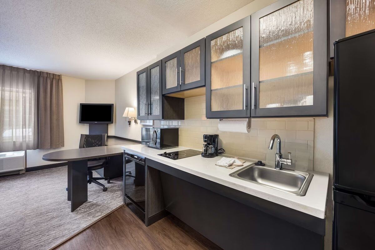 Cook easy meals with a sleek kitchenette and modern finishes.