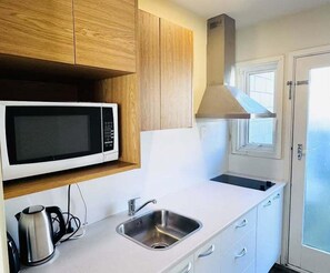 Fridge, coffee/tea maker, electric kettle, dining tables