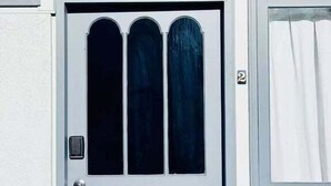 A white door with three glass panels and a small window to the right.