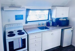 Electric kettle, toaster, dining tables - Merivale Court One Bedroom Apartment-Unit 8 (Christchurch)