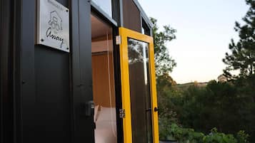 A modern building with a sign indicating it is managed by a tiny away service.